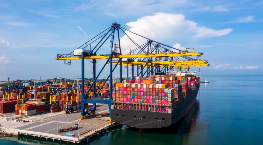 Image of a vessel loading a container at a port